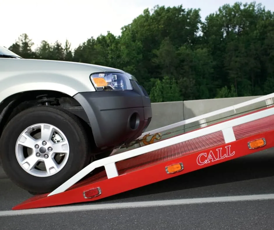 Barrie tow truck loading a vehicle on a residential street